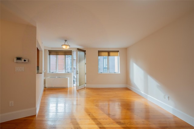 empty room with light hardwood / wood-style floors