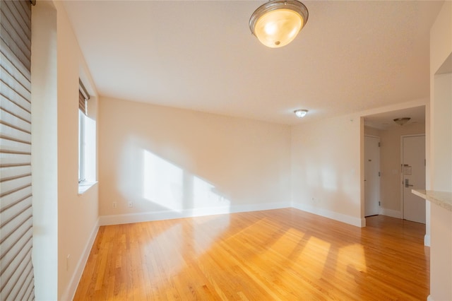 empty room with hardwood / wood-style floors