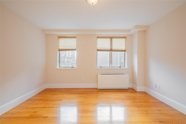 unfurnished room with light wood-type flooring