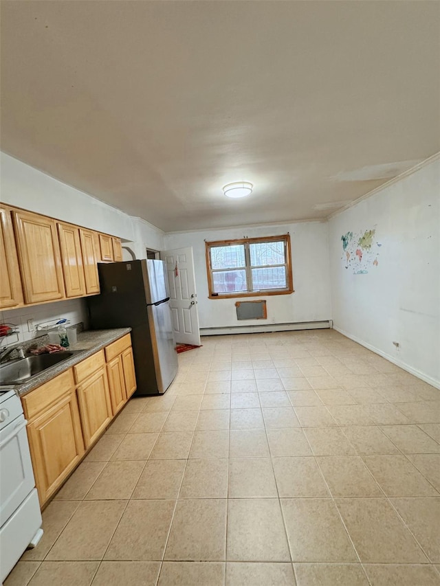 kitchen featuring sink, light tile patterned floors, a baseboard radiator, range, and stainless steel refrigerator