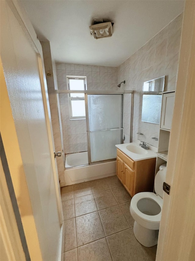 full bathroom with tile patterned floors, vanity, toilet, and enclosed tub / shower combo