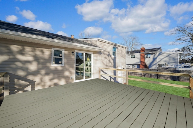 wooden deck with a lawn