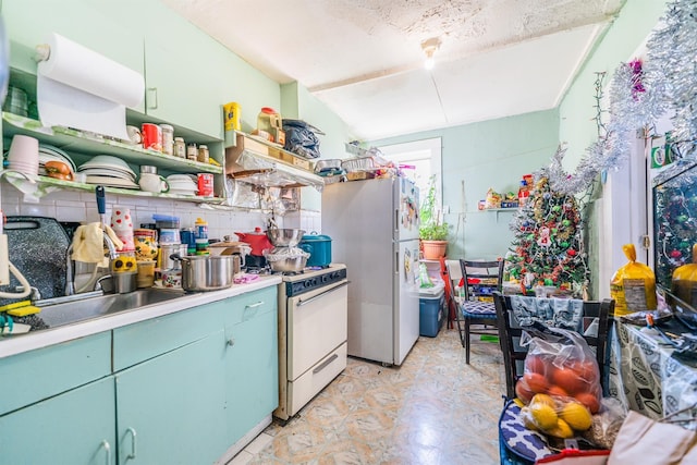 kitchen featuring backsplash, sink, and white appliances