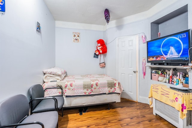 bedroom with dark wood-type flooring