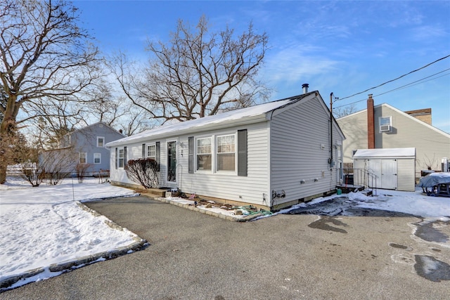 view of front of home featuring a shed