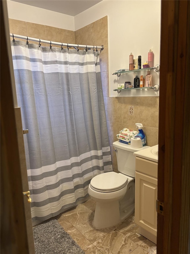 bathroom featuring a shower with shower curtain, vanity, toilet, and tile walls