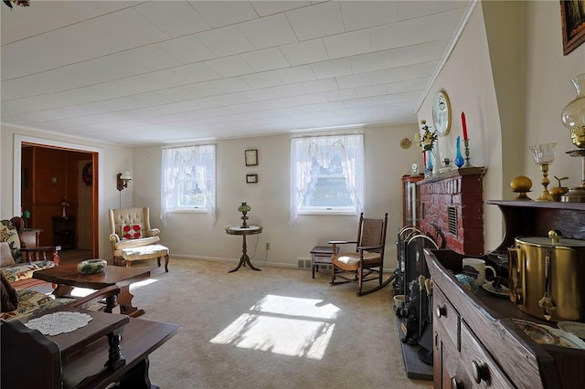 living area featuring light carpet and a brick fireplace