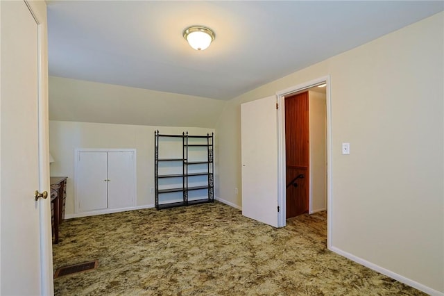 additional living space with lofted ceiling and carpet flooring