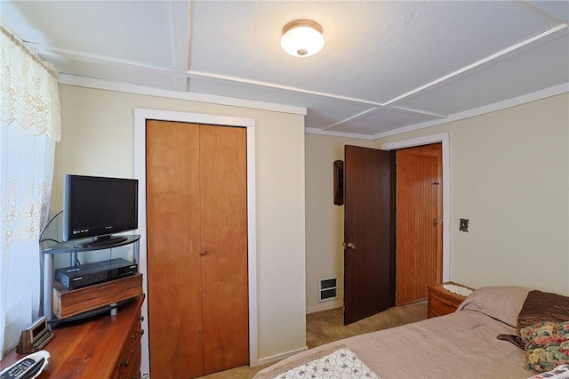 bedroom with light colored carpet and a closet