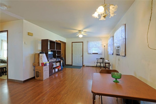 interior space featuring ceiling fan with notable chandelier, hardwood / wood-style floors, and cooling unit