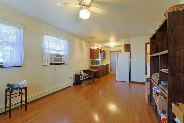 kitchen with hardwood / wood-style flooring, ceiling fan, cooling unit, a baseboard heating unit, and white refrigerator