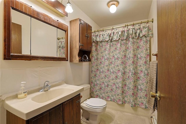 bathroom with a baseboard radiator, vanity, and toilet