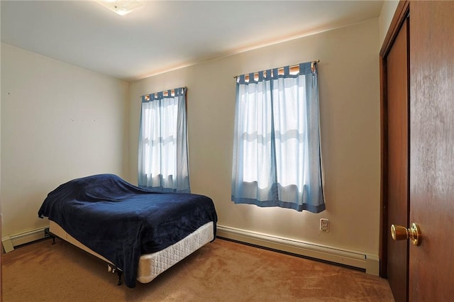 carpeted bedroom with a baseboard radiator