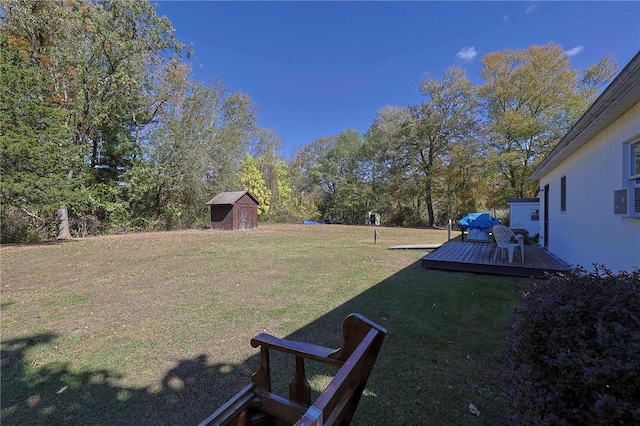 view of yard featuring a storage shed and a deck