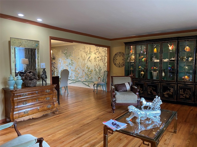 living room with hardwood / wood-style flooring and ornamental molding