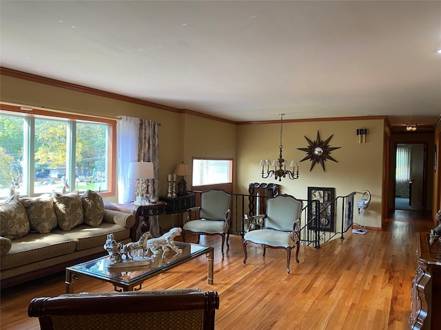 living room featuring a chandelier, wood-type flooring, a wealth of natural light, and ornamental molding