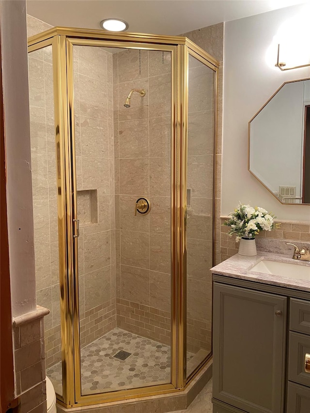 bathroom featuring vanity and a shower with shower door