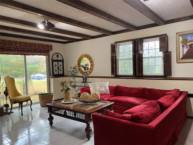 living room with beamed ceiling and light tile patterned floors