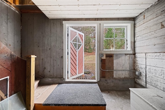 entryway with wood walls