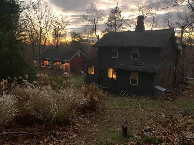 view of back house at dusk