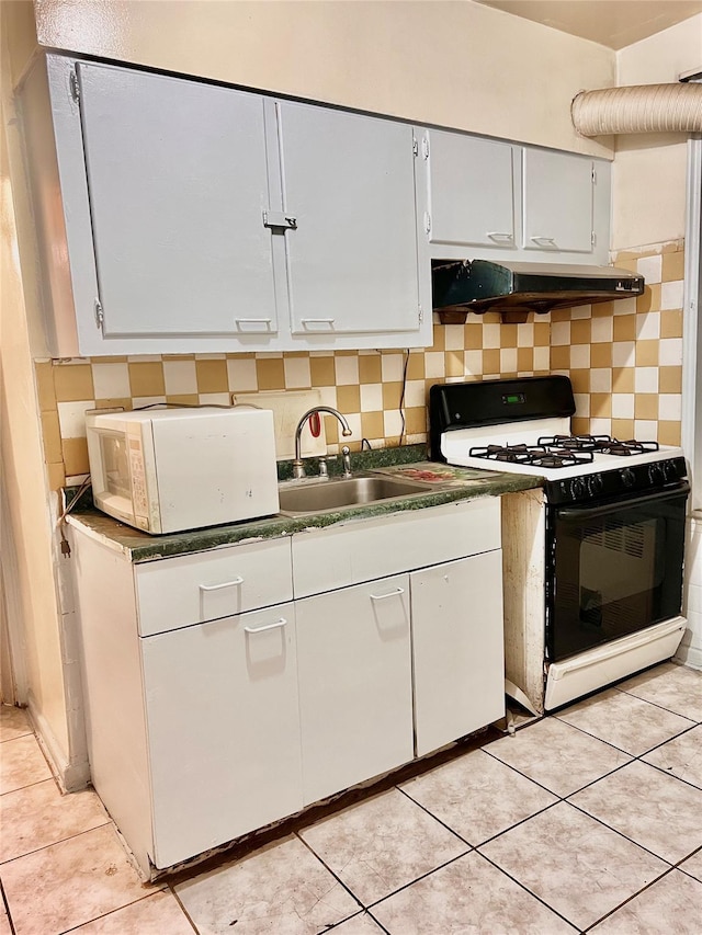 kitchen with light tile patterned flooring, white appliances, sink, and tasteful backsplash