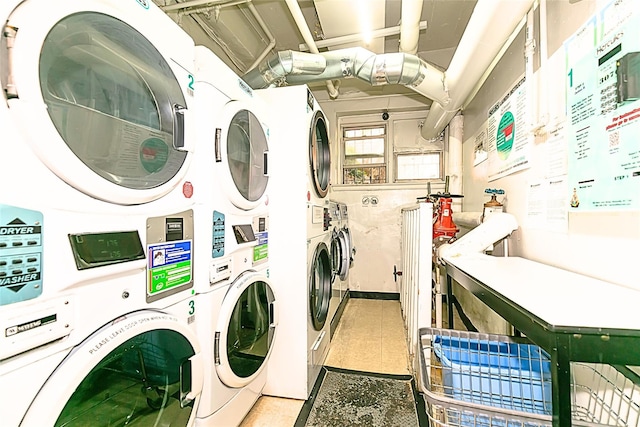 clothes washing area with washing machine and dryer and stacked washer and clothes dryer