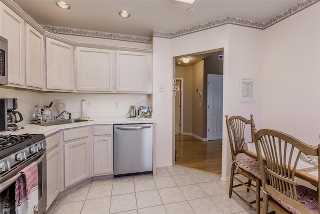 kitchen featuring light tile patterned floors, sink, and appliances with stainless steel finishes