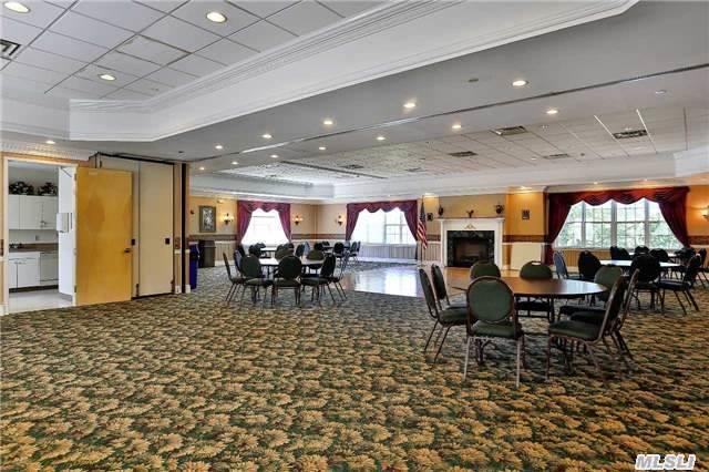 dining space with carpet floors, a raised ceiling, and ornamental molding