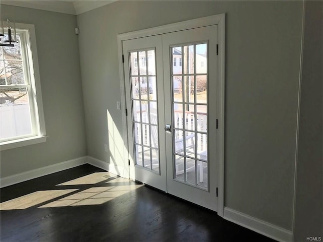 doorway to outside featuring plenty of natural light, baseboards, dark wood-style flooring, and french doors