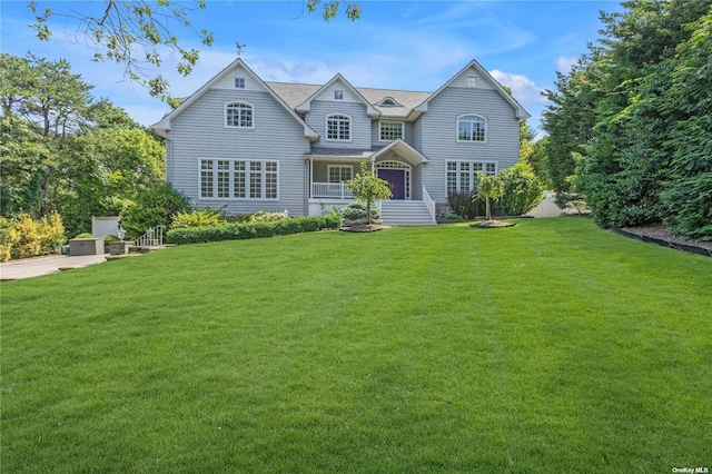 view of front facade with a front lawn and a porch