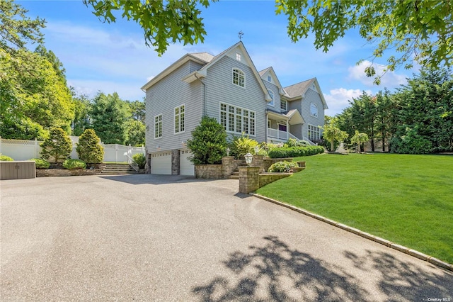 front of property with a garage and a front yard