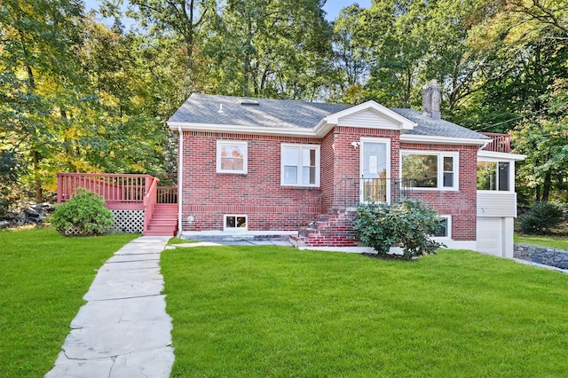 view of front facade featuring a garage, a front yard, and a wooden deck