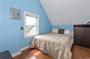 bedroom featuring vaulted ceiling and dark wood-type flooring