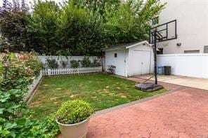 view of yard featuring a shed and a patio