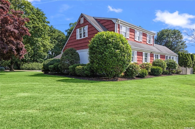 view of side of home featuring a yard