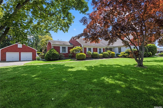 cape cod home featuring a garage, an outbuilding, and a front lawn