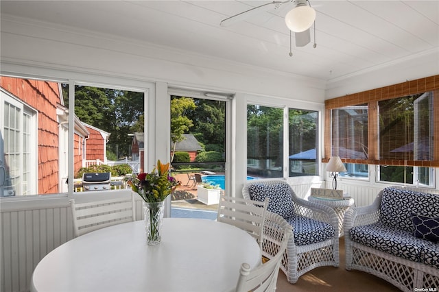 sunroom with a wealth of natural light and ceiling fan