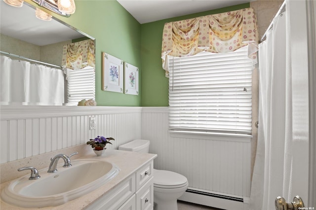 bathroom with vanity, toilet, and a baseboard heating unit