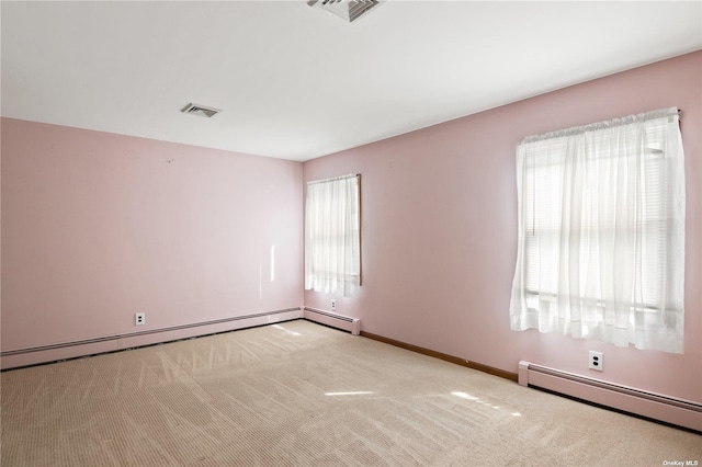 carpeted empty room featuring a baseboard radiator