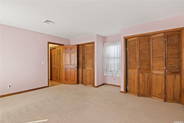 unfurnished bedroom featuring light carpet