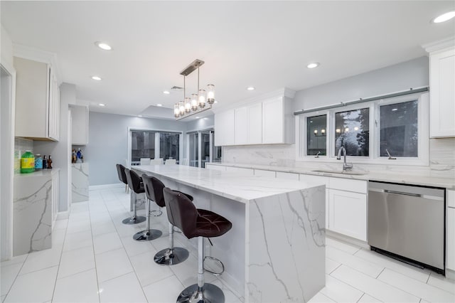 kitchen with dishwasher, a kitchen island, white cabinetry, and sink