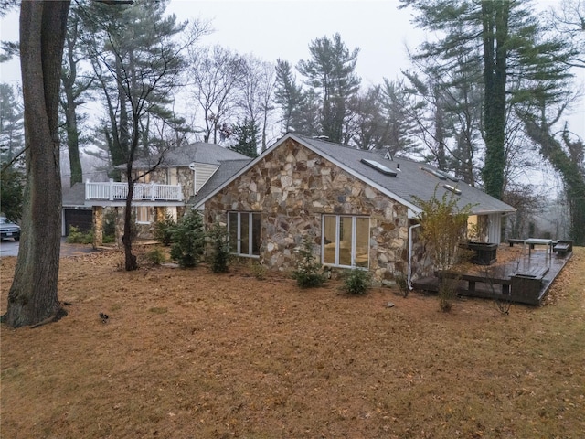 back of property featuring a balcony