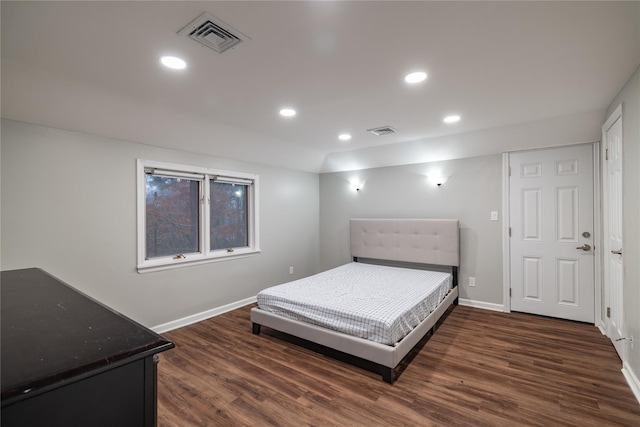 bedroom with dark wood-type flooring