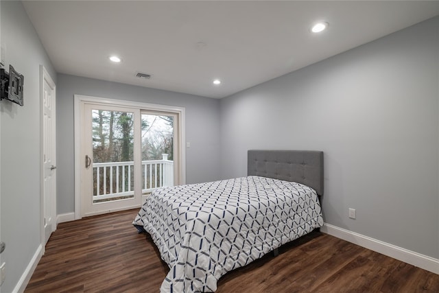 bedroom featuring dark hardwood / wood-style flooring and access to exterior