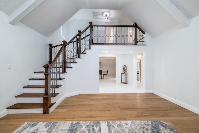 stairs featuring hardwood / wood-style floors