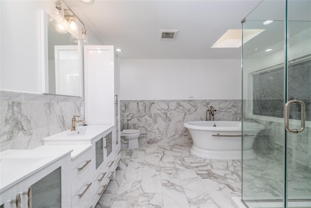 full bathroom with vanity, separate shower and tub, toilet, and tile walls