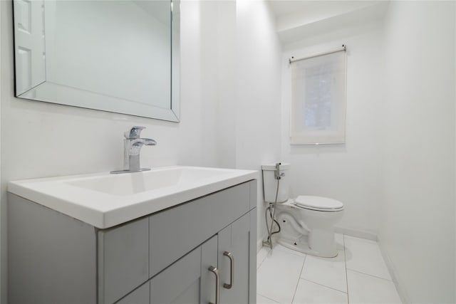 bathroom featuring tile patterned flooring, vanity, and toilet