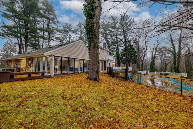 rear view of house featuring a sunroom