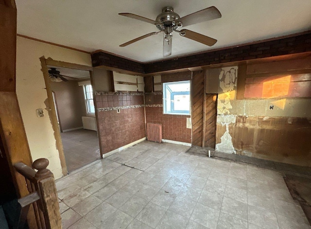 interior space with ceiling fan and radiator heating unit