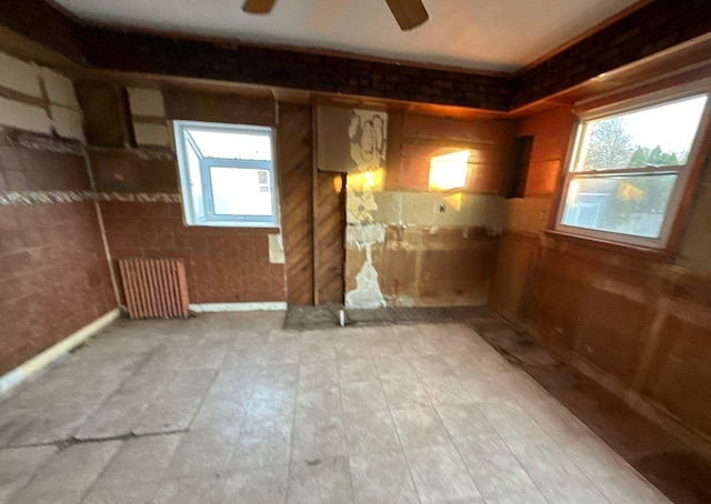 spare room featuring ceiling fan and radiator heating unit